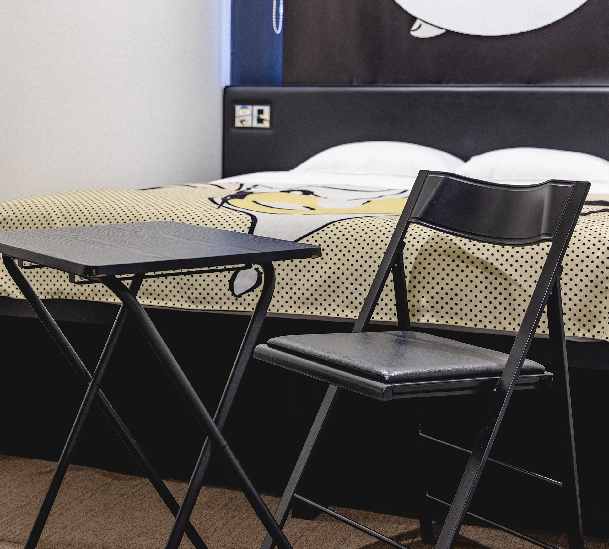 The room has a foldaway table and chair.